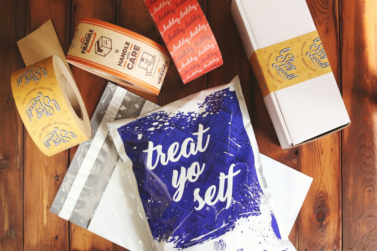 Home Packaging supplies for small businesses on a wooden table.