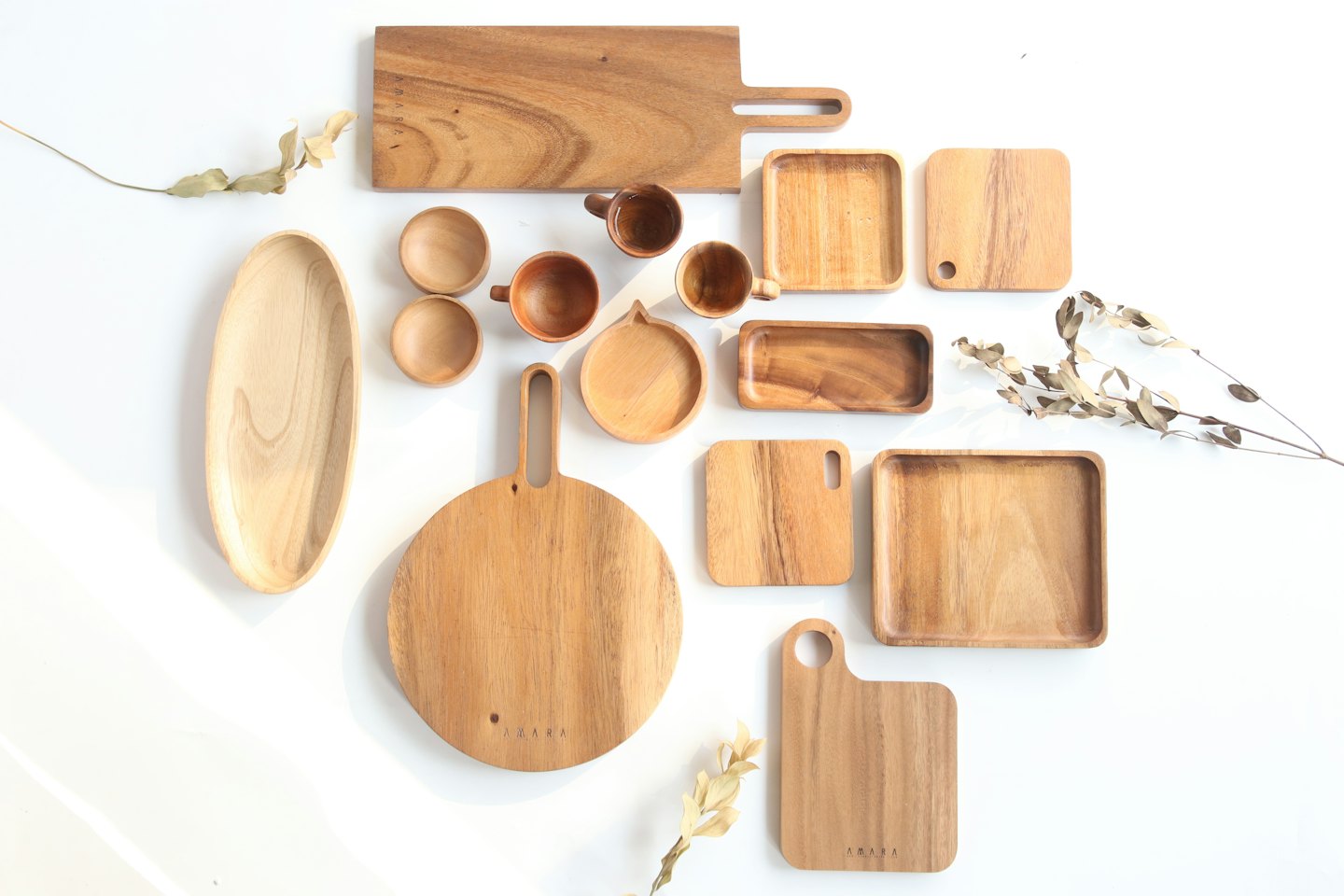 Home Natural wood kitchen items arranged on a white surface.